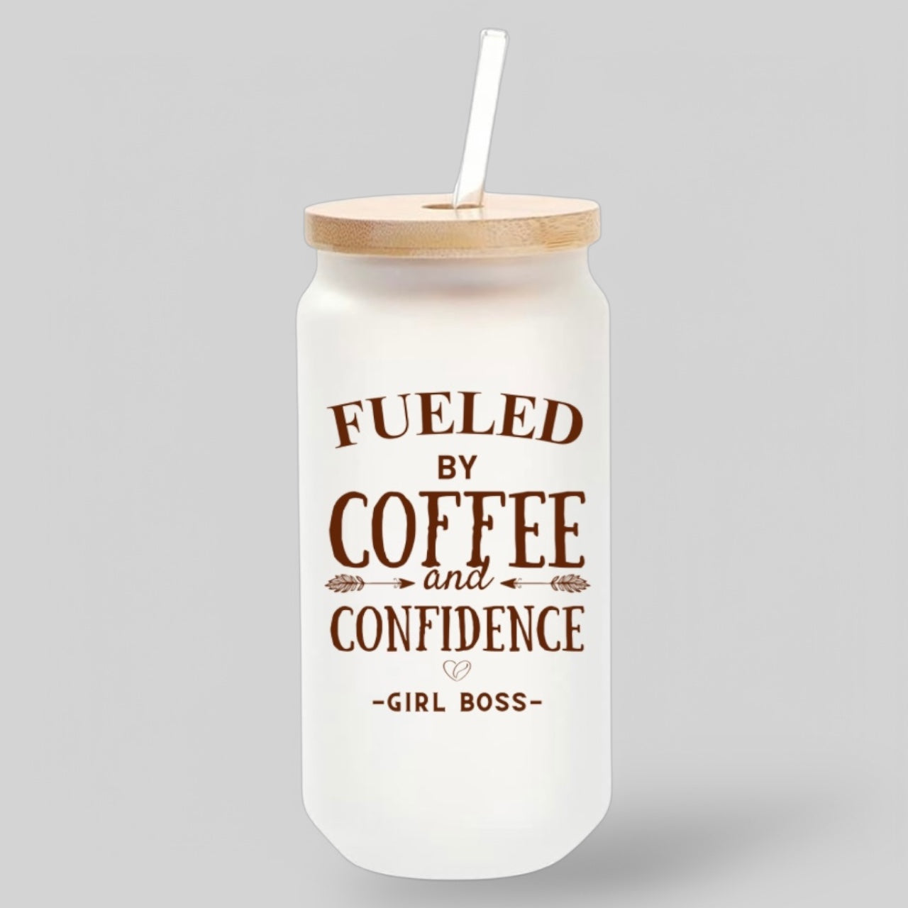 Frosted glass tumbler with bold brown typography that reads 'Fueled by Coffee & Confidence' with a bamboo lid and glass straw, designed for coffee lovers and entrepreneurs