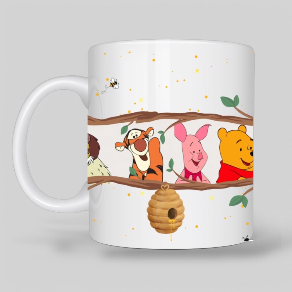 White ceramic mug featuring Winnie the Pooh, Piglet, Tigger, and Eeyore on a tree branch with a honey pot and bees, creating a cozy and nostalgic Disney-inspired design.