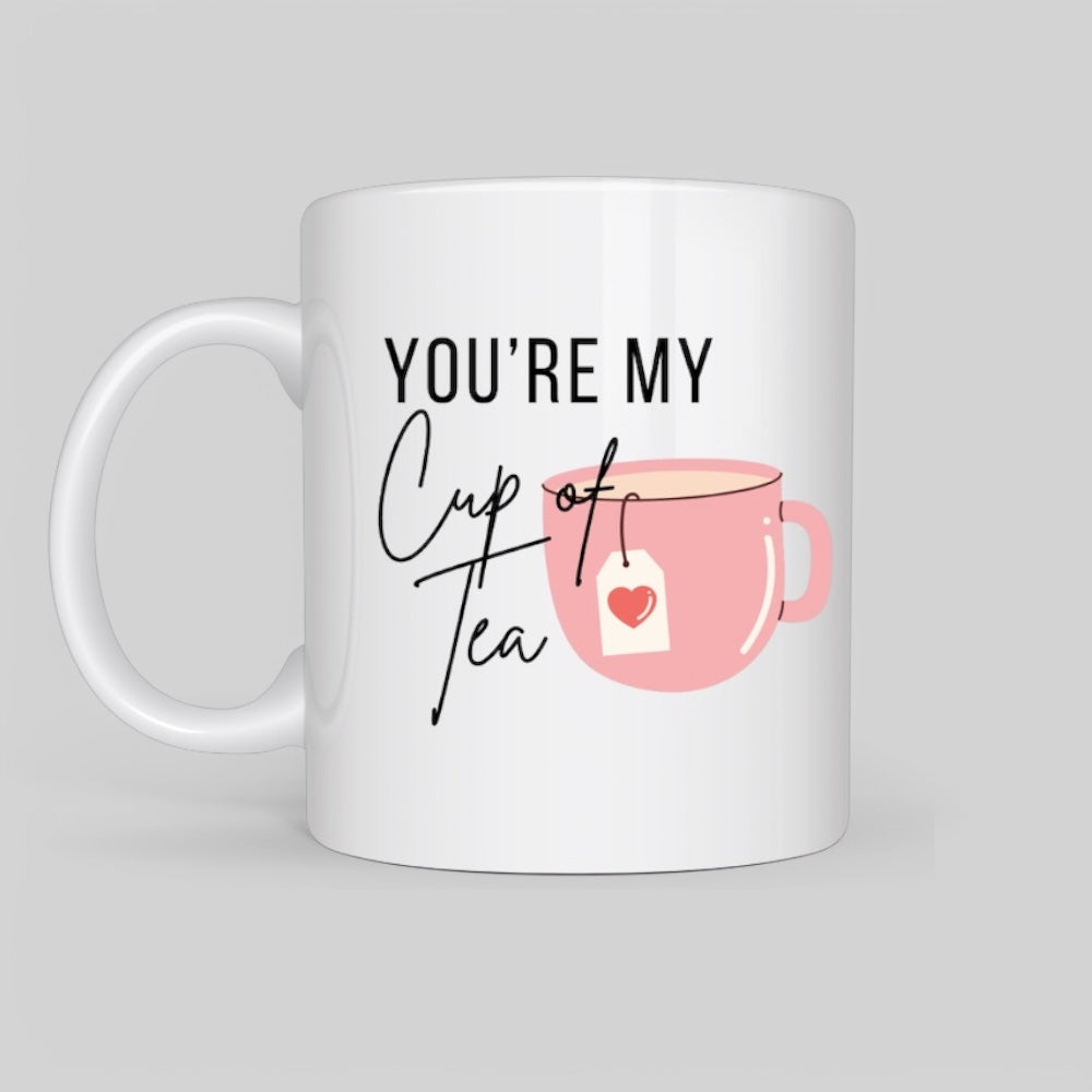 White ceramic mug with a pink tea cup illustration and the phrase 'You're My Cup of Tea' in elegant typography, perfect for tea lovers and romantic gifts.