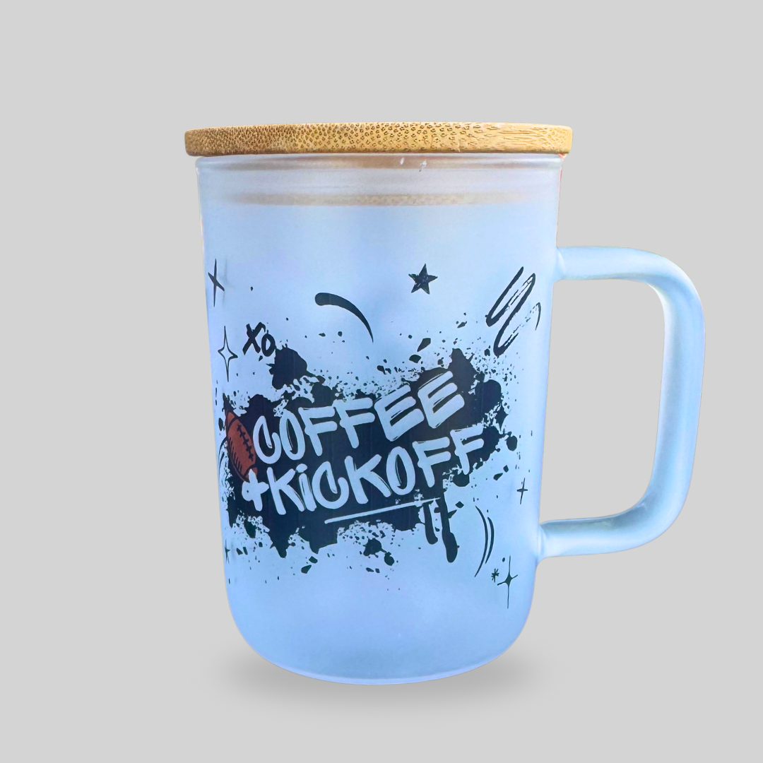 Frosted glass mug with handle, bamboo lid, and Coffee + Kickoff football design — reusable cup with glass straw for game day coffee or iced drinks.