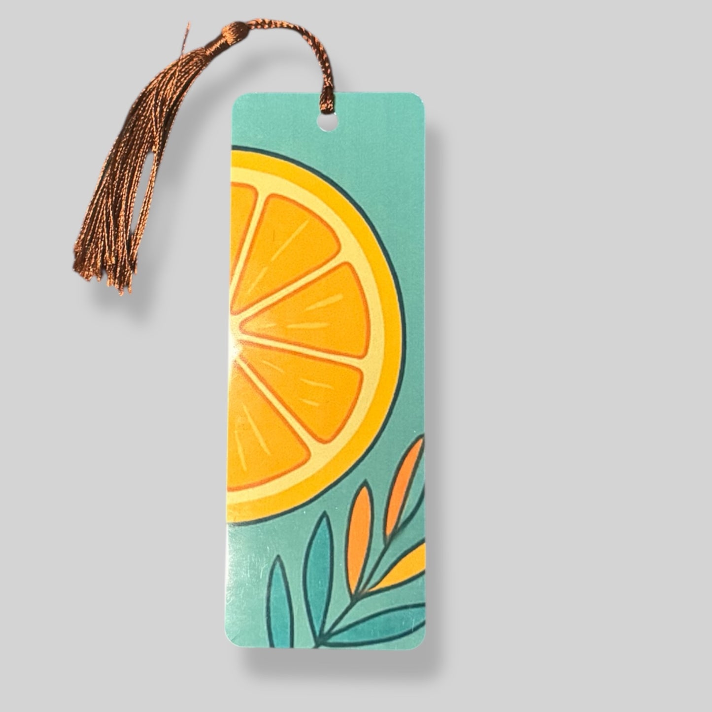 Bright orange citrus slice with leaves, set against a teal background for a bold and fresh bookmark design.