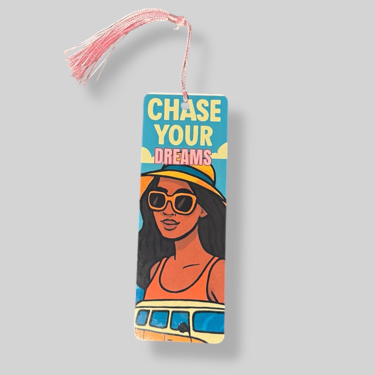 Confident Black woman with hat and sunglasses in front of a van, with bold “Chase Your Dreams” text overlay.