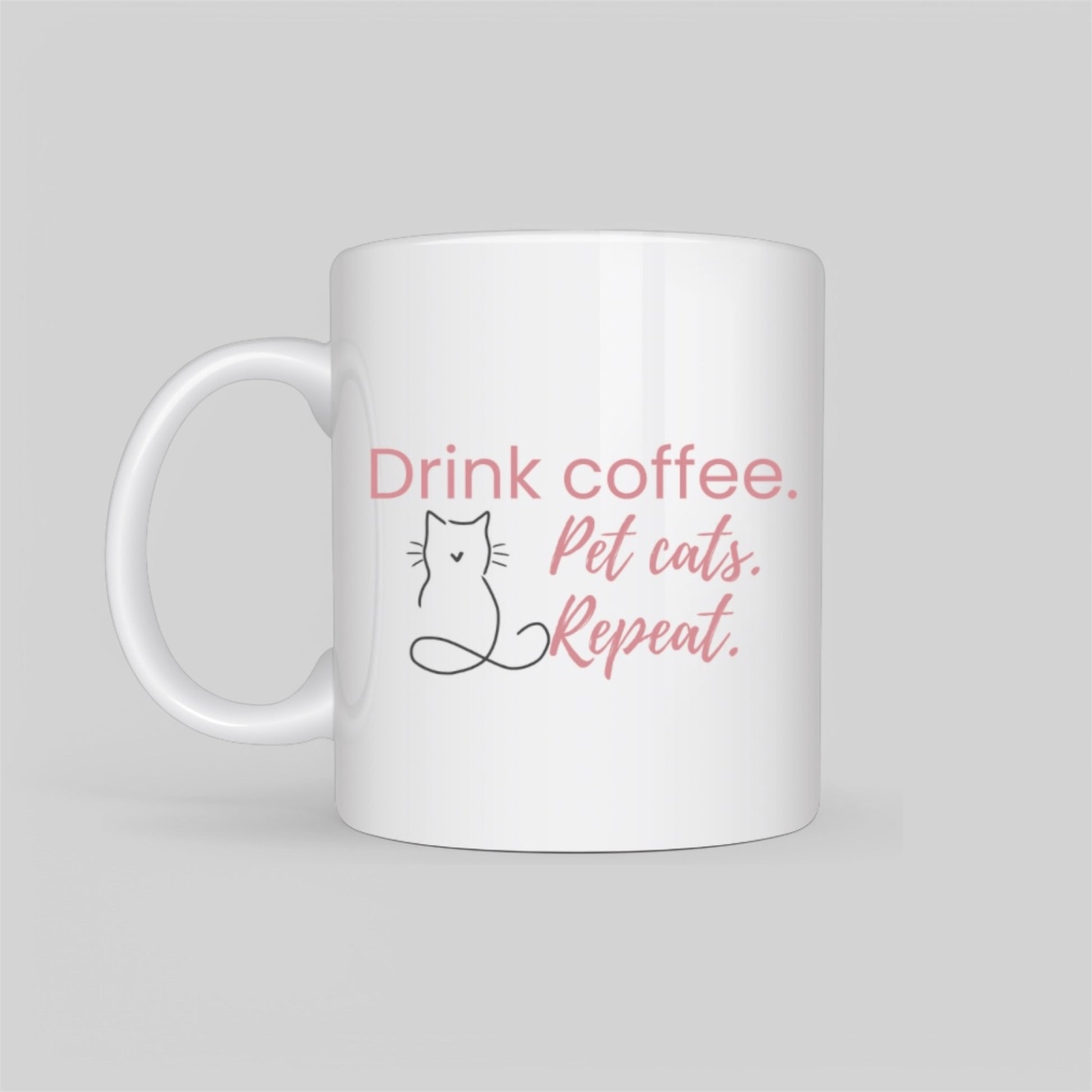 White ceramic coffee mug featuring a minimalist cat outline and the phrase “Drink Coffee. Pet Cats. Repeat.” in soft blush tones. A perfect gift for cat moms, pet lovers, and coffee addicts.