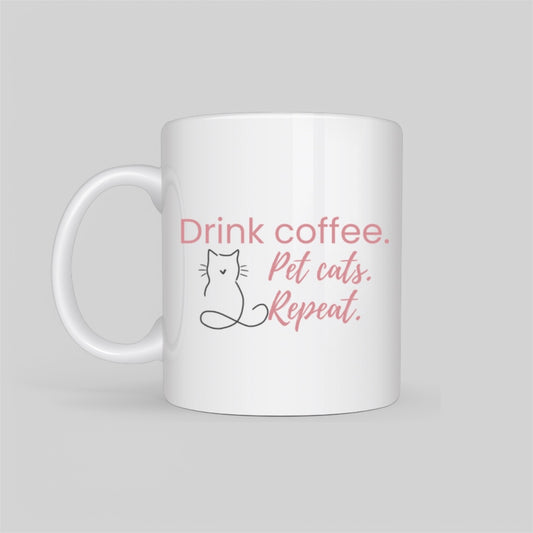 White ceramic coffee mug featuring a minimalist cat outline and the phrase “Drink Coffee. Pet Cats. Repeat.” in soft blush tones. A perfect gift for cat moms, pet lovers, and coffee addicts.