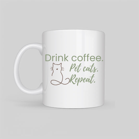 White ceramic coffee mug featuring a minimalist cat outline and the phrase “Drink Coffee. Pet Cats. Repeat.” in soft blush tones. A perfect gift for cat moms, pet lovers, and coffee addicts.