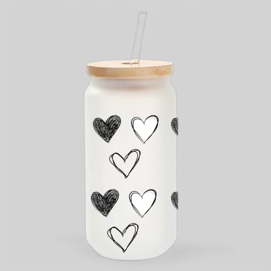 Minimalist frosted glass tumbler with black and white sketched hearts, featuring a bamboo lid and glass straw for a modern iced coffee drinking experience
