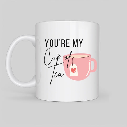 White ceramic mug with a pink tea cup illustration and the phrase 'You're My Cup of Tea' in elegant typography, perfect for tea lovers and romantic gifts.