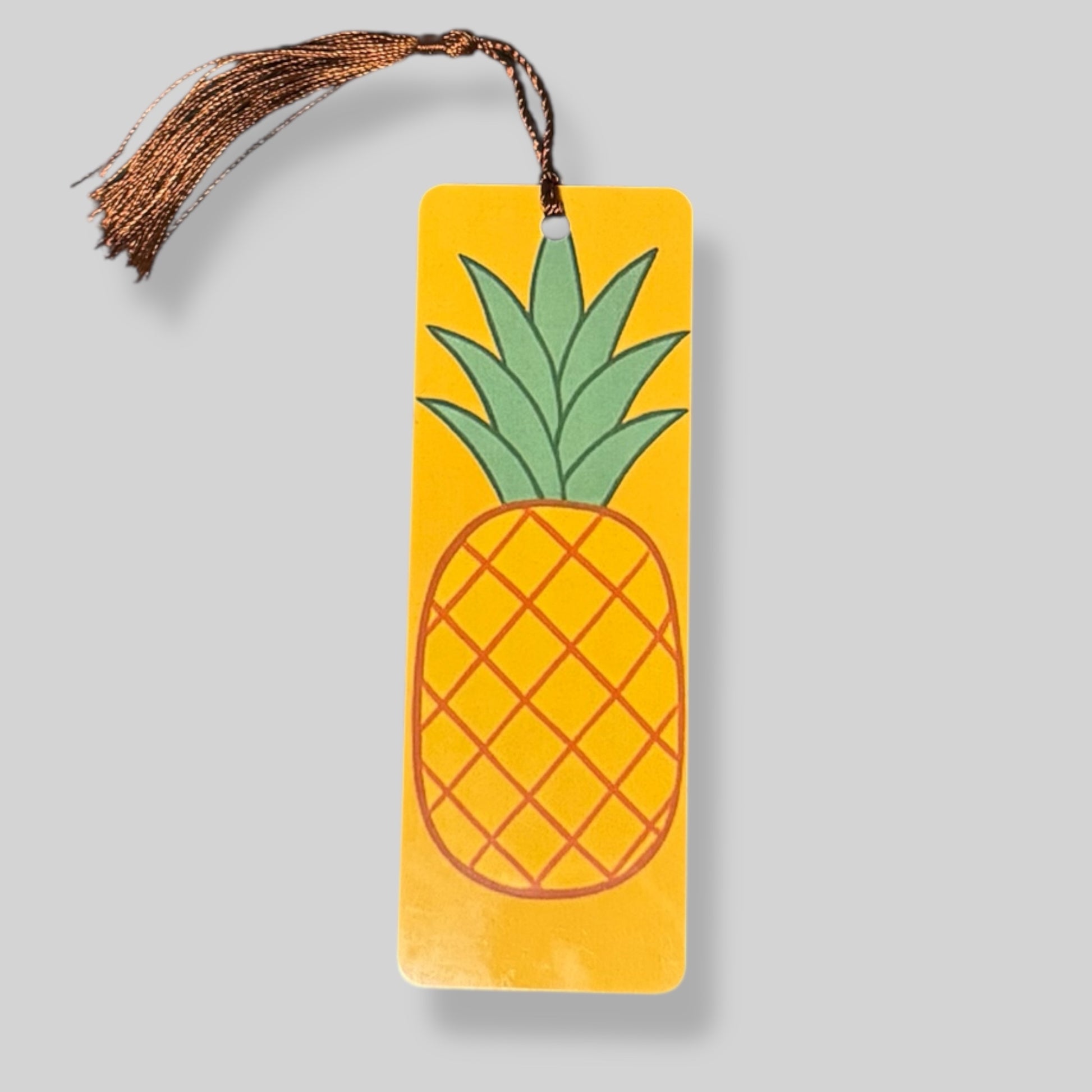 Yellow pineapple on a rich orange background for a summer fruit-themed bookmark.